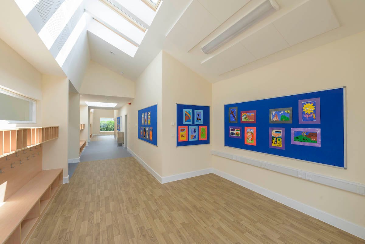 School corridor with children's artwork displayed on walls.