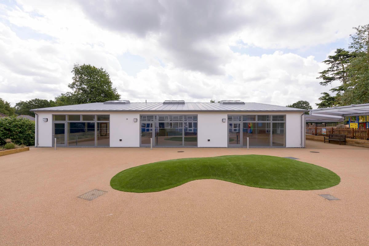 Modern school building with large playground.