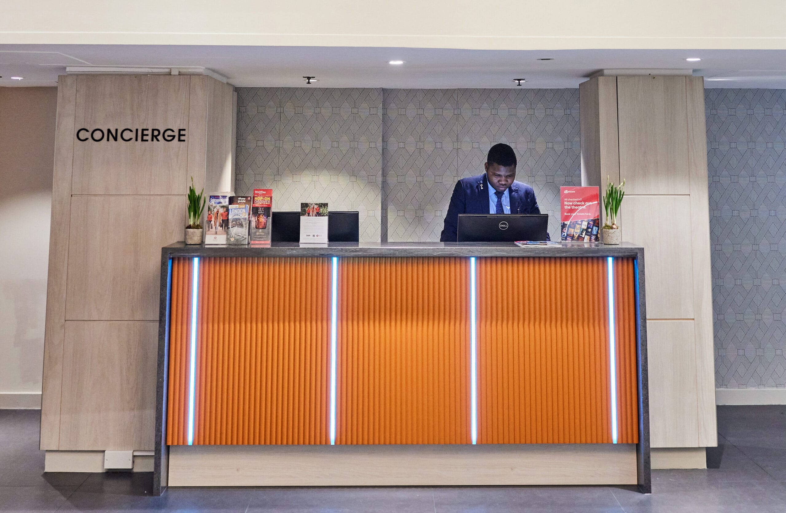 Hotel concierge desk, orange frontage