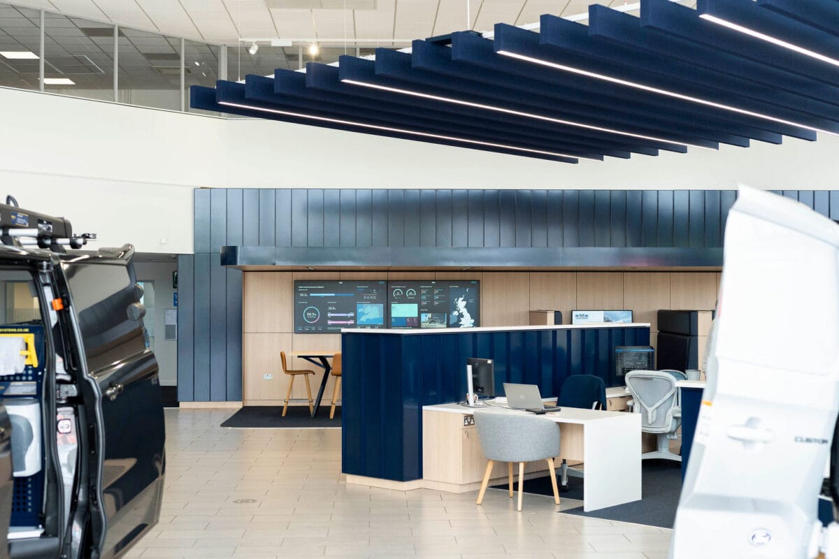 Modern vehicle showroom with desks and digital displays