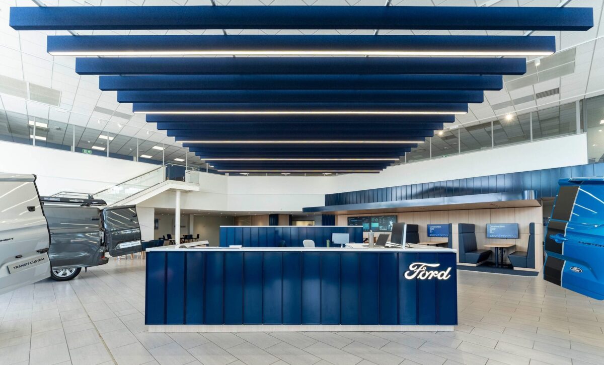 Modern Ford showroom with vans and reception desk