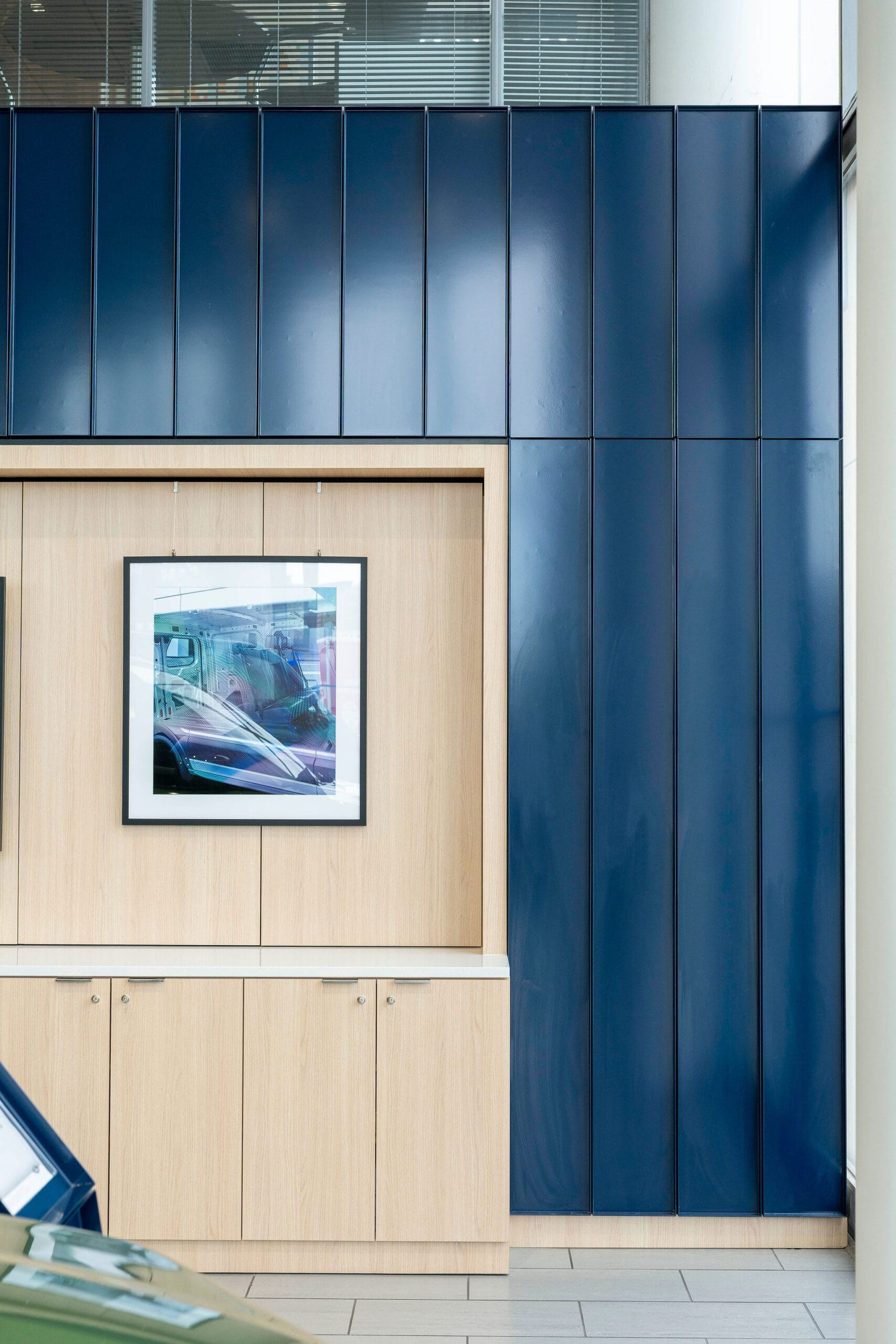 Modern interior with blue panels and framed car photo
